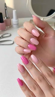 A close-up image of stylish pink acrylic nails expertly manicured, showcasing various shades of soft pastel pinks and vibrant magenta. The nails have a glossy, high-shine finish that reflects light beautifully. In the foreground, the hands are elegantly poised on a minimalist white surface, with a subtle spa-like texture underneath. The background features a blurred array of professional nail tools and a compact mirror, softly lit with warm, natural light to create an inviting atmosphere. The angle is slightly above the hands, allowing the viewer to appreciate the delicate details of the nail art. The overall mood is fresh, chic, and perfect for summer, emphasizing the elegance and simplicity of the pink acrylic trend. stylish pink acrylic nails expertly manicured, showcasing various shades of soft pastel pinks and vibrant magenta